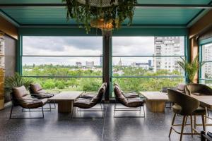 a room with chairs and tables and large windows at Campeador Expo in Bucharest