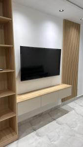 a flat screen tv sitting on top of a wall at Allaoua in Stamboul