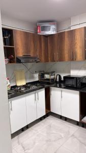 a kitchen with white cabinets and a stove at Allaoua in Stamboul
