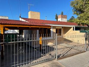 a fence in front of a house at Casa céntrica en calle CB 297 in Villa Carlos Paz
