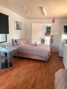 a bedroom with a bed with a dog laying on it at Cunnamulla Tourist Park in Cunnamulla