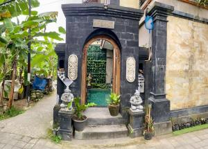a entrance to a building with a blue door at Dede House 1 Private Pool in Ubud