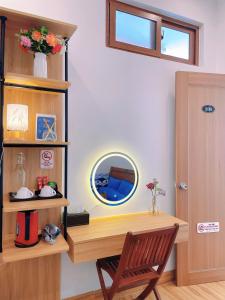 a room with a desk with a mirror and a chair at Mie's Homestay in Danang