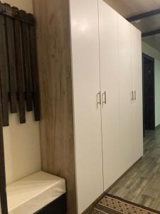 a locker room with white cabinets and a bench at Vorzel house in Vorzel +22 photos