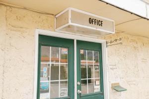 an office sign above a door of a building at 1 BR Suite 9 at Green Gables Resort in Osoyoos