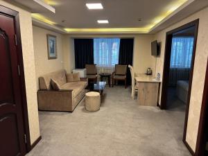 a living room with a couch and a table at Sayohat Hotel in Tashkent