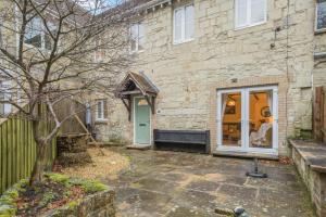 a stone house with a blue door and a tree at 3 Bed in Shanklin oc-b36038 in Shanklin
