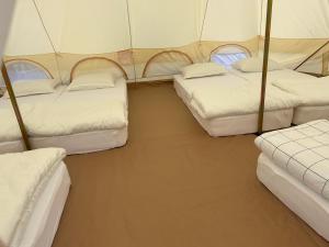 a room with four beds in a tent at Casa Alexia in Potoc