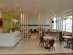 a restaurant with tables and chairs in a cafeteria at ibis Styles Ponta Pora in Ponta Porã