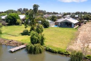 an aerial view of a house next to a river at Woodbine Waters Lakehouse in Yarrawonga