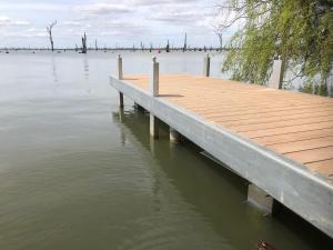 a dock on a body of water at Woodbine Waters Lakehouse in Yarrawonga