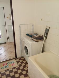 a washer and dryer in a bathroom with a tub at Domček v Turnej in Trenčianska Turná