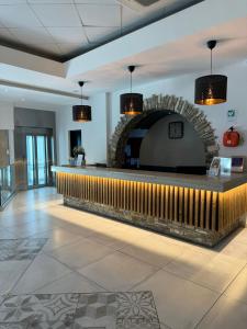 a lobby with a brick fireplace and a bar at Cyprotel Florida in Ayia Napa +98 photos