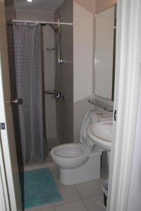a bathroom with a toilet and a sink at Azure Tropical Paradise in Manila