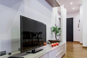 a large flat screen tv sitting on a entertainment center at So Suite Rome in Rome