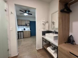 a bathroom with a sink and a ceiling fan at San Jeronimo Suites in Monterrey +20 photos