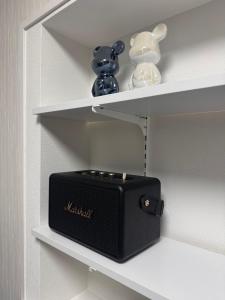 a black speaker is sitting on a shelf at 一軒家貸切 THREE FIELD Kobe Nakayamate in Kobe