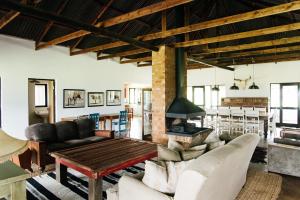 a living room with a couch and a table at The Cowshed in Lydenburg