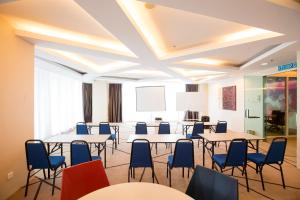 a room with tables and chairs and a white ceiling at Cozy Home with Spectacular View in Bayan Lepas