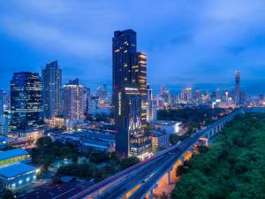 a city skyline at night with a highway at Mercure Bangkok Makkasan in Bangkok