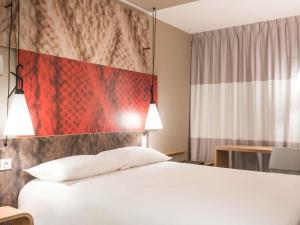 a bedroom with a white bed and a flag at ibis Guaiba in Guaíba