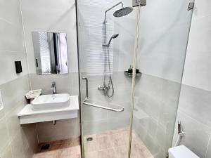 a bathroom with a shower and a sink at Coconut Hotel in Phú Quốc