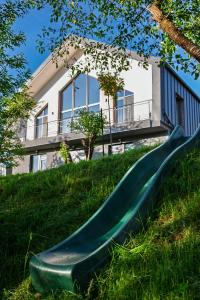 a slide in the grass in front of a house at Bran Villa - A-frame Orchard Hygge in Bran