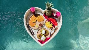 a table of food on a boat in the water at Oasis Dune Villas Lombok in Kuta Lombok