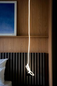 a pair of white shoes hanging from a wall at ALPAMI Boutique Glockenbach in Munich