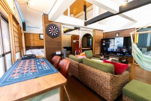 a living room with two couches and a table at コテージくつろぎ in Tsuru 