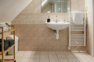a bathroom with a sink and a staircase at Mountain Chalet Donovaly with Sauna & Jacuzzi in Donovaly +30 photos