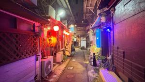 an alley with purple and blue lights in a building at Volcano in Kagoshima