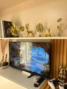a flat screen tv sitting on a shelf at Cozyluxe at Pine Suites Tagaytay in Kaybagal