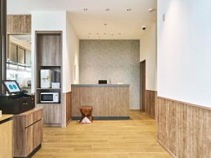 an office lobby with a counter and a desk at TORANOMONHOLIC Hotel in Tokyo
