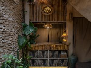 a room with a table with a lamp and plants at HAVAN Villas - Yogyakarta in Jarakan +95 photos