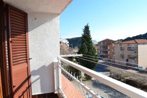 a balcony with a door and a view of a street at Apartment Matea in Petrovac na Moru