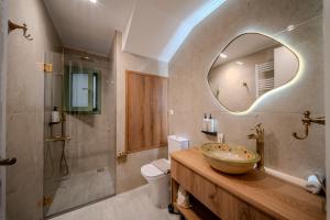 a bathroom with a sink and a mirror at Leon Suites Nemea in Neméa +91 photos
