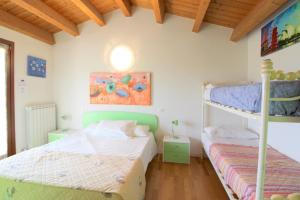 two bunk beds in a room with wooden ceilings at Oasis Blue Resort - Hotel & Residenz Apartments Strandnähe in Caorle +196 photos