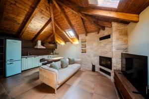 a living room with a couch and a fireplace at Leon Suites Nemea in Neméa