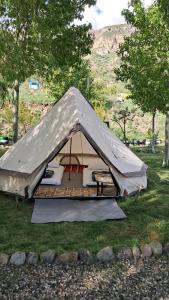 a tent sitting in the grass in a field at GeghardCamping in Goghtʼ