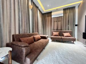 a living room with a couch and two chairs at The Benjamins Pool Villa in Jodhpur