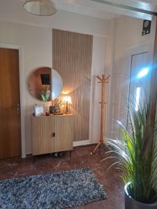 a room with a mirror and a dresser with a plant at Cozy country house in Preveza +10 photos