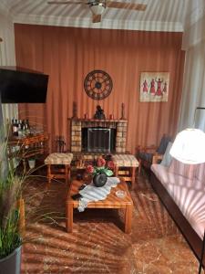 a living room with a couch and a fireplace at Cozy country house in Preveza