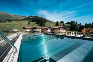 a swimming pool in front of a house at ELGUS Nature Retreat in Brentonico