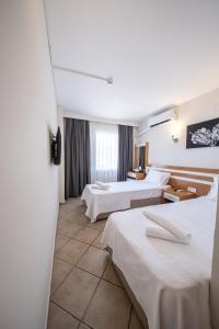 a hotel room with two beds and a window at SUNMARİS CİTY HOTEl in Marmaris +30 photos