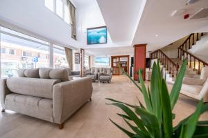 a living room with a couch and chairs in a building at SUNMARİS CİTY HOTEl in Marmaris