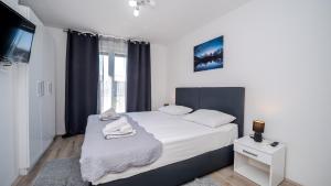 a bedroom with a large bed and a window at Villa Rab Paradise pool by Villas Guide in Lopar +49 photos