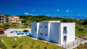 an aerial view of a white house with a yard at Villa Rab Paradise pool by Villas Guide in Lopar