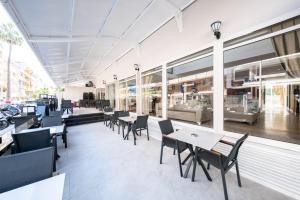 a restaurant with tables and chairs and windows at SUNMARİS CİTY HOTEl in Marmaris
