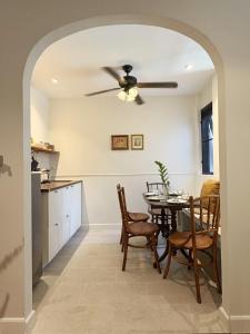 a kitchen and dining room with a ceiling fan at Pennkiat House in Bangkok +28 photos